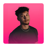 a man in a black shirt is standing in front of a pink background